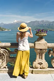 Hats Prints: Tourist admiring Como lake view from the balcony of villa del Balbianello on punta