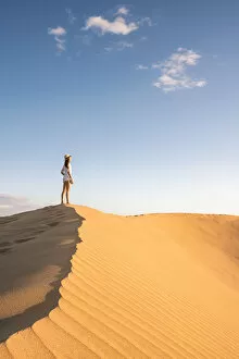 Dune Gallery: Tourist admiring the view on sand dunes. Maspalomas, Las Palmas, Gran Canaria