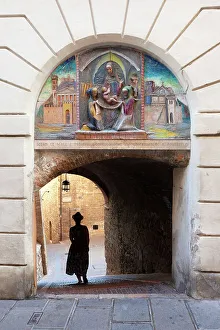 Steps Prints: A tourist in a alley of Assisi, Assisi, Perugia province, Umbria, Italy. (MR)