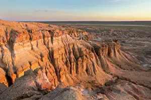 Minerals Prints: Tourist atop the sand-cliffs of Tsagaan Suvarga (White Stupa) at sunrise, Mongolia