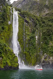 Fiord Prints: Tourist boat approaching Stirling Falls in Milford Sound in Fiordland National Park