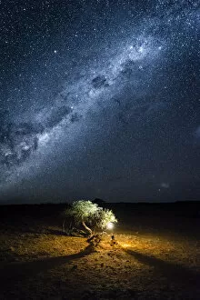 Africa Gallery: Tourist camping outdoor admiring the stars of the Southern Hemisphere, Namibia, Africa