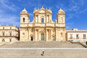 Tourist climbing the stairs of St nicholas church cathedral of Noto, Siracusa province