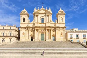 Tourist climbing the stairs of St nicholas church cathedral of Noto, Siracusa province