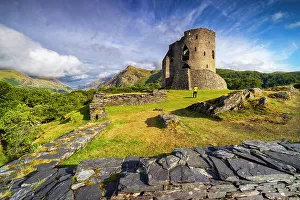 Snowdonia Prints: A tourist observes Dolbadarn Castle during summer
