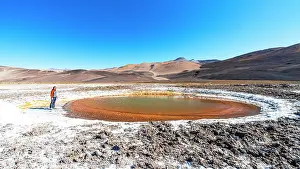 Salt Pond Prints: Tourist observing a salt pond, Ojos del Campo