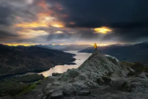 Cloud Prints: A tourist a t Ben A'an summit during summer with the view of Loch Katrine