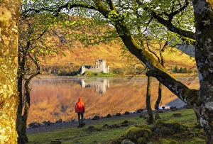 15th Century Prints: A tourist among the trees during a foggy sunrise at Kilchurn Castle