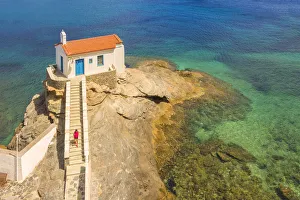 A tourist visiting St. Thalassini church, Andros, Cyclades Archipelago, Greece, Europe