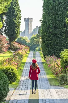 Towers Collection: A tourist walks along a pathway in Sigurt√ park. Valeggio sul Mincio, Verona, Veneto, Italy (MR)