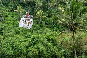 Jungle Collection: Tourist woman swinging over the Balinese tropical forest, Ubud, Indonesia