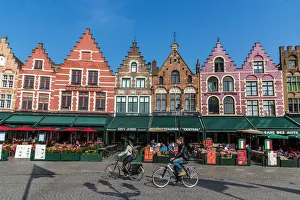 Market Square Prints: Tourists biking in Markt or Market Square, Bruges, West Flanders, Belgium