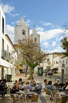 Images Dated 3rd April 2017: Tourists at a cafe and the church of Santo Antonio. Lagos Portugal
