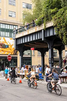 Bikes Collection: Tourists cycling under the High Line, New York, USA