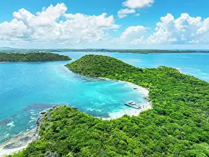 Snorkeling Prints: Tourists enjoying bathing in the crystal sea on idyllic beach in the lush Green Island during a boat tour
