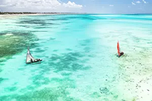 Dhow Prints: Tourists enjoying a boat trip on traditional dhow in the crystal sea
