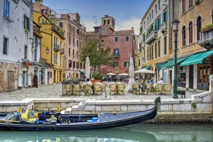 Piazza Prints: Tourists seated in an outdoor cafe in a small square of Venice, Veneto, Italy