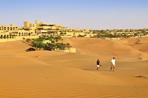 Norbert Eisele Hein Prints: Tourists wander through dunes outside the desert luxury hotel Anantara Qasr Al Sarab