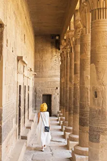 Temples Gallery: toursit walking through the Temple of Philae on an island in Lake Nasser, Nile River