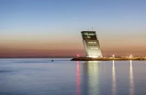 The Tower of Maritime Control in Alges at dusk, overlooking the Tagus river and the