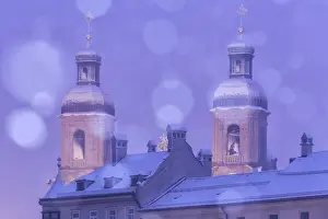 Rooftop Prints: The towers of the St. Jakob cathedral on a snowy evening as seen from the Innbruecke bridge