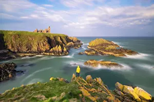 Slains Castle Prints: A tpurist observes Slains Castle at sunset