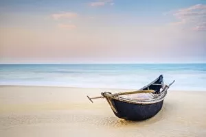 Sandy Collection: Traditional bamboo basket fishing boat on the beach at sunset, Thuan An Beach, Phu Vang District