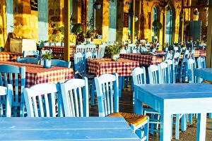 Traditional blue tables and chairs of a Greek restaurant (taverna), Chania, Crete, Greece