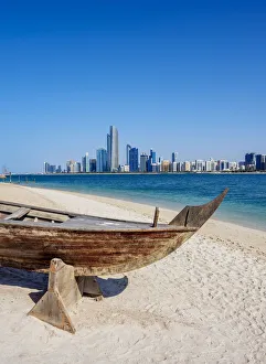 Images Dated 10th January 2018: Traditional boat in the Heritage Village with city skyline in the background, Abu Dhabi