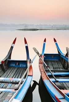 Traditional Burmese boats at sunrise on Taungthaman Lake, Amarapura, Mandalay, Burma