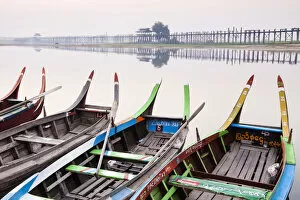 Images Dated 20th May 2013: Traditional Burmese boats at sunrise on Taungthaman Lake with U Bein Bridge in the