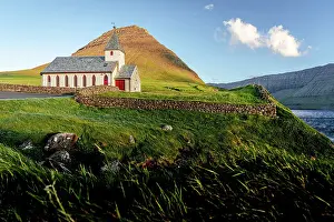 Vidareidi Prints: Traditional church of Vidareidi overlooking the ocean at sunset