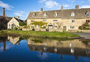 Traditional Cotswold cottages and a water mill reflected in the river Eye, Lower Slaughter Traditional Cotswold cottages and a water mill reflected in the river Eye, Lower Slaughter