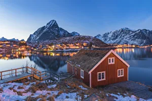 Reine Prints: Traditional fishermen house above Reine Bay at dusk in winter. Reine, Nordland county