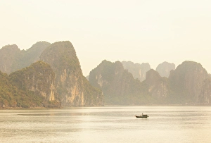 Northeast Vietnam Prints: Traditional fishing boat and limestone islands at dawn, Halong Bay, Northeast Vietnam