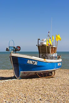 Hastings Prints: A traditional fishing boat on the shingle beach at Hastings, Sussex, England
