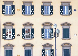 Traditional house decorated with Pisa symbol on the bank of Arno River, Pisa, Tuscany
