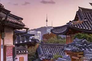 Traditional houses in Bukchon Hanok village and Namsan Seoul Tower at dusk, Seoul