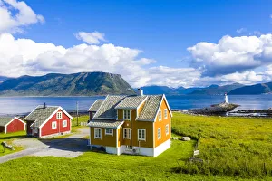 Scandinavian Culture Prints: Traditional houses next to Hogsteinen Lighthouse by the sea, Godoya Island, Alesund