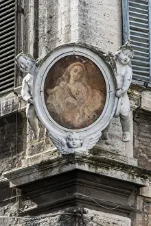 Traditional Madonnella or Madonna painting placed in a buildings corner, Rome, Lazio