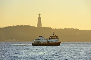 A traditional passenger boat (cacilheiro) crossing the Tagus river between Almada