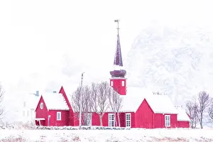 Finish Prints: Traditional red church of Flakstad covered with snow in winter