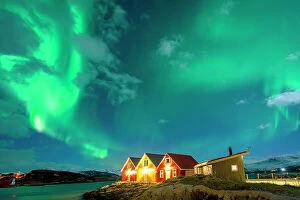 Fjord Collection: Traditional rorbu hit by Northern Lights in winter, Sommaroy, Troms og Finnmark, Norway