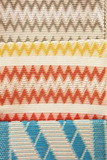 Cultural Heritage Prints: Traditional Sardinian textile works on the display in a shop of the historical cask of Pula