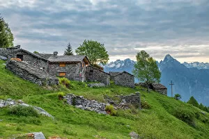 Images Dated 14th August 2019: Traditional stone huts with high peak Pizzo di Prata in background, Alpe Buglio