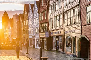 Lens Flare Prints: Traditional timber buildings lit by sunset, Bryggen, Bergen, Hordaland County, Norway