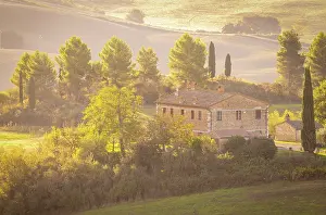 Rolling Hills Prints: Traditional Tuscan farmhouse set amongst trees and rolling hills