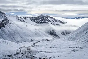 Trail leading through snow covered valley during winter to Rainbow Mountain, Uchullujllo