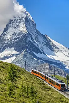 Ski Resort Prints: Train along the Gornergrat mountain rack railway with Matterhorn in the foreground