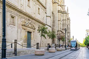 Metro Prints: Tram passing outside Seville Cathedral, Seville, Andalusia, Spain